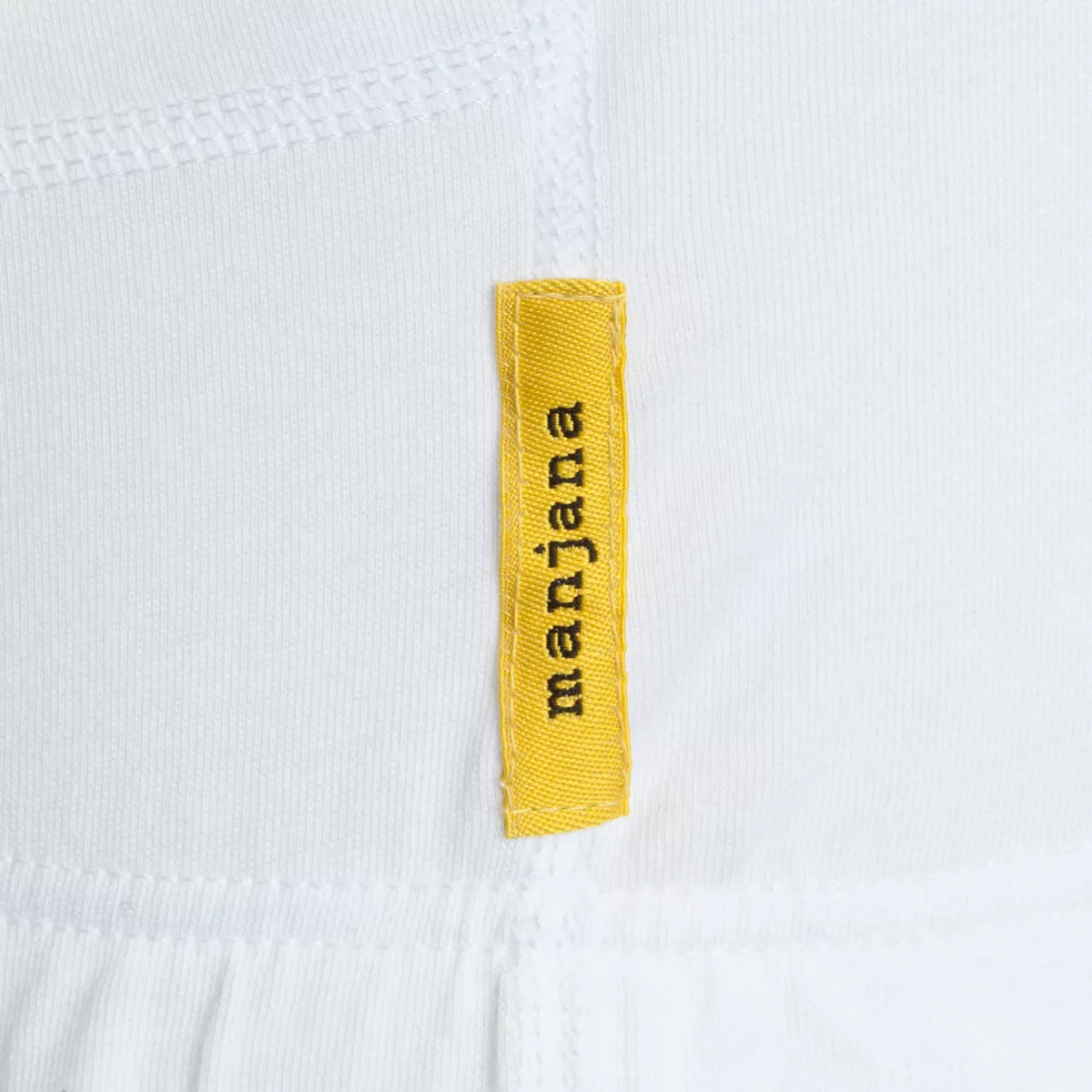 Close-up of a white sweatstop garment featuring a yellow fabric side label with black branding.